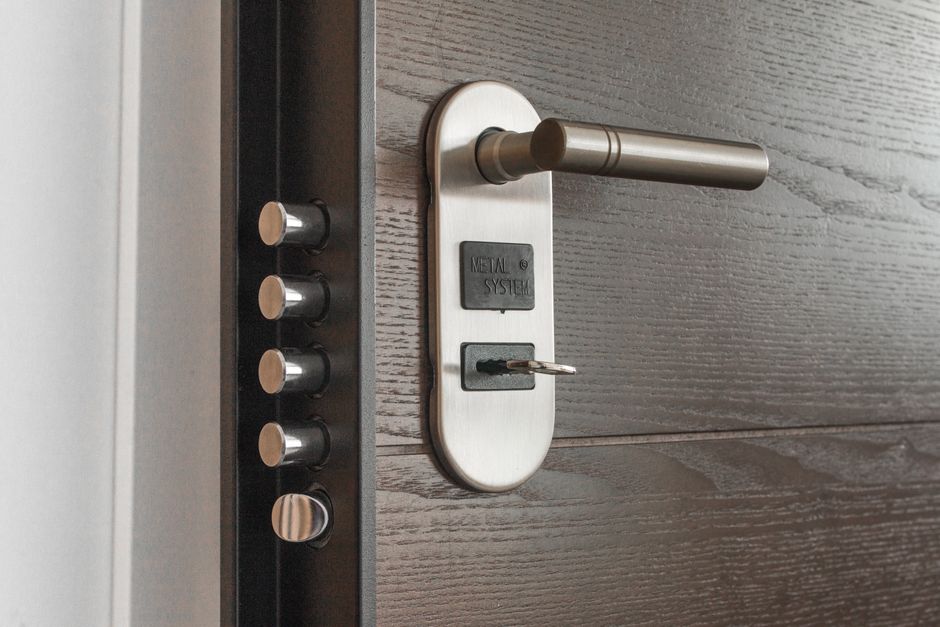 A close-up of a deadbolt lock engaged on an apartment front door