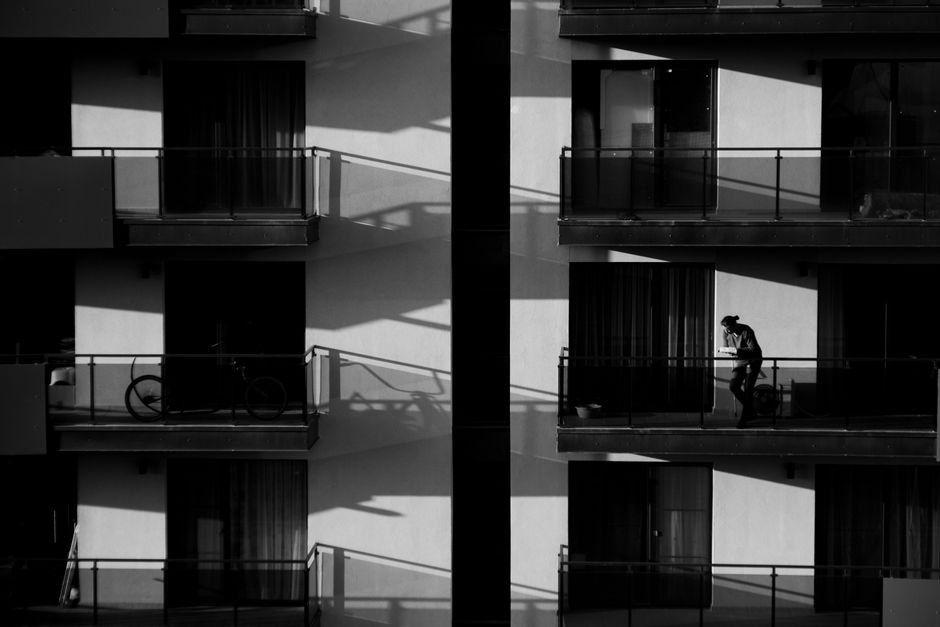 A resident stepping into an apartment building elevator, the kind of everyday moment where holding the door open becomes a sm