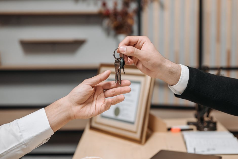 A set of apartment keys resting on a signed rental lease document