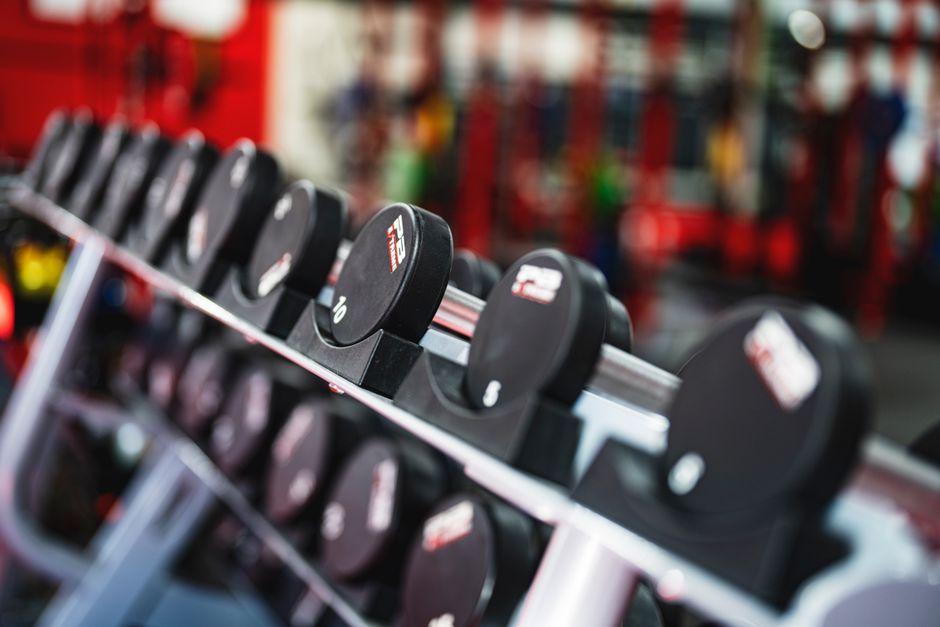 Dumbbells returned in numerical order on a gym rack, illustrating the weight-return habit