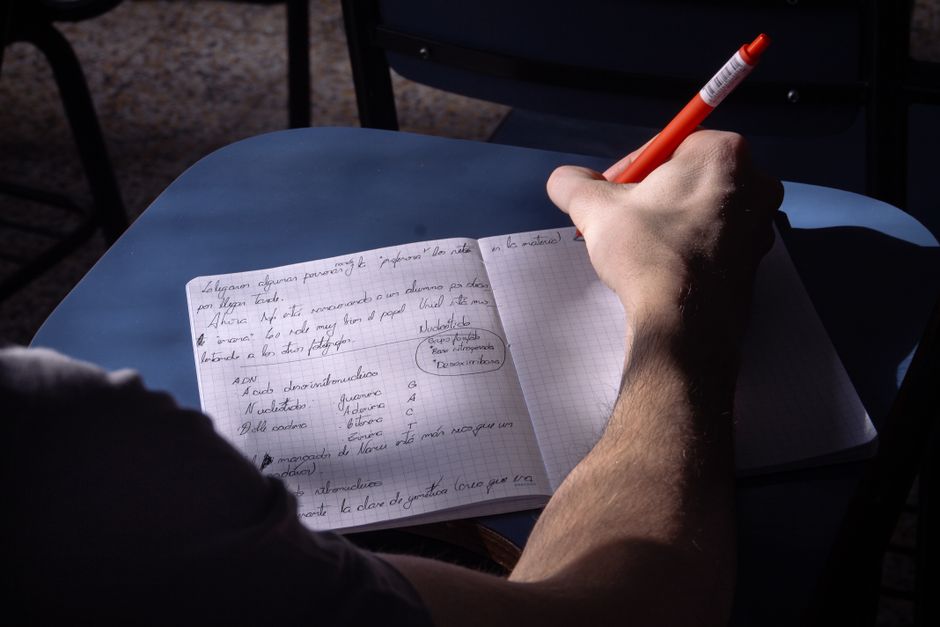 Hands writing dated notes in a notebook to document repeated incidents
