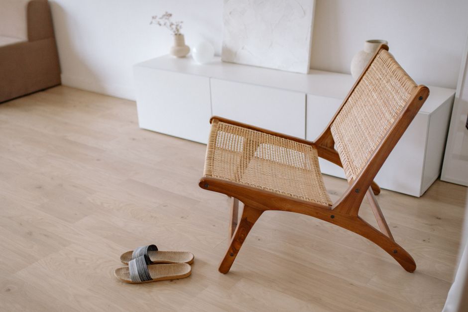 Soft slippers worn on a hardwood floor, the kind of quiet footwear that softens footstep impact for the apartment below.