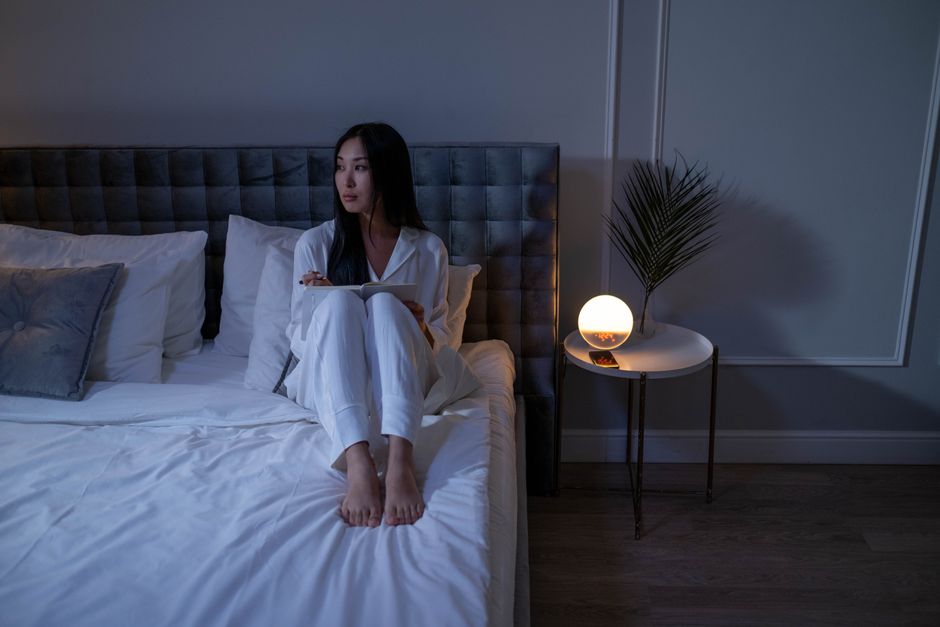 A small white noise machine on a table, used to mask the sound of a barking dog