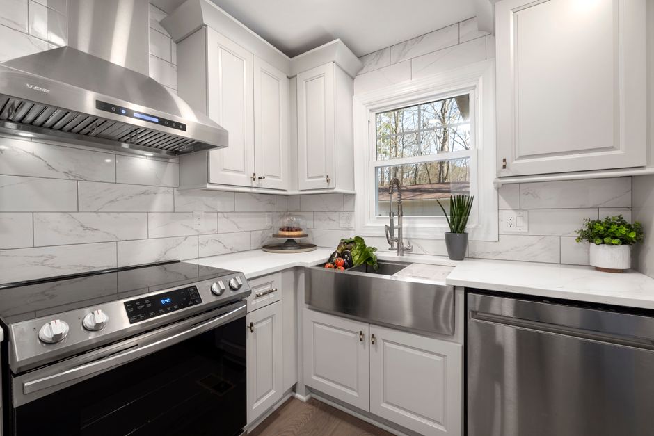 A stainless steel kitchen range hood mounted over a stovetop