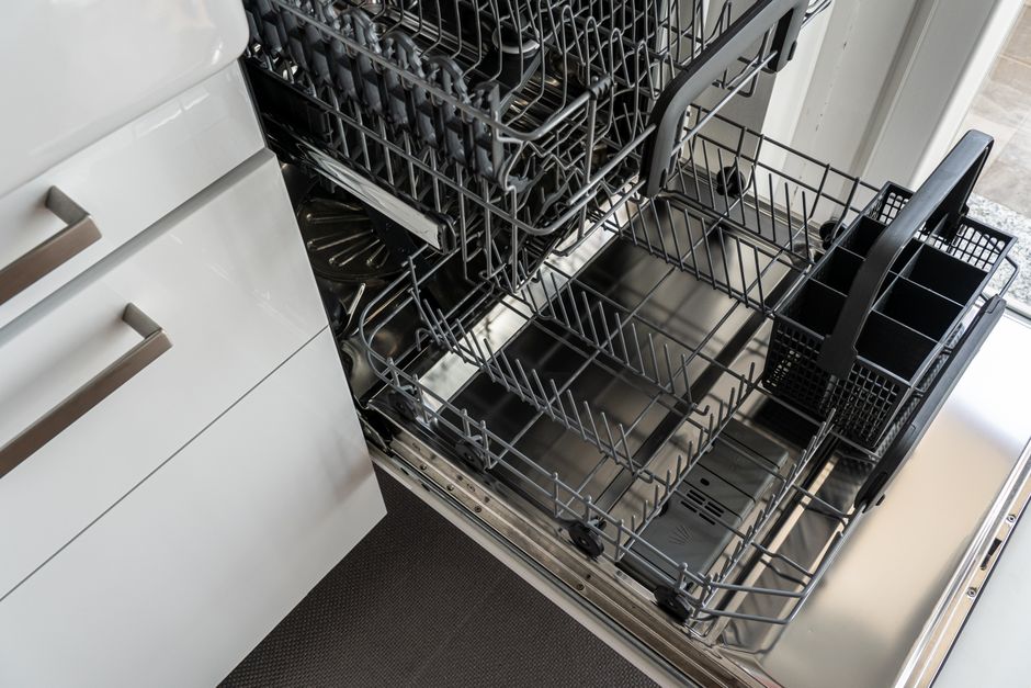 An open dishwasher in an apartment kitchen, the kind of convenience appliance repair that rarely warrants aggressive pushing.