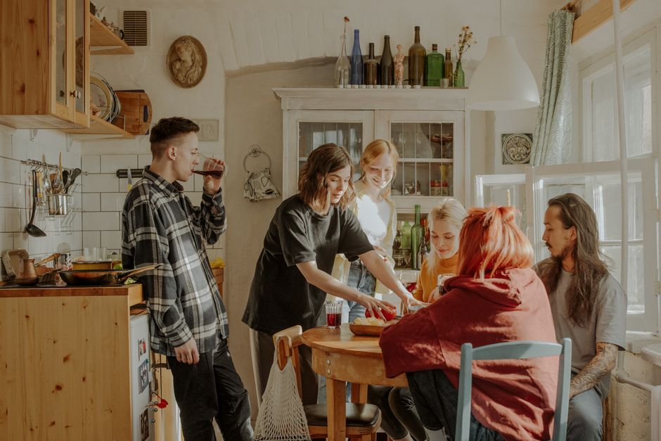A shared apartment kitchen with common counter and dishes, the kind of space roommates negotiate over