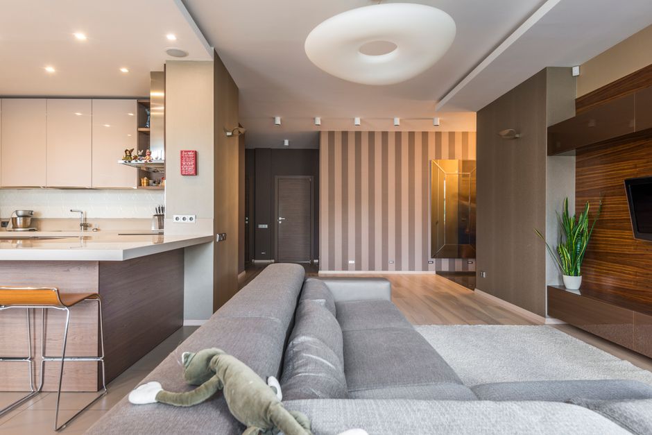A tidy small apartment living room with a nearly bare coffee table and minimal decor, showing an uncluttered, open feeling