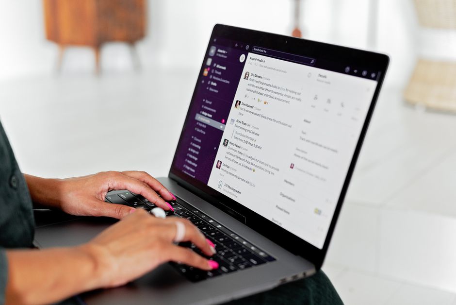 A person at a laptop drafting a polite follow-up email to a landlord about a pending repair request.