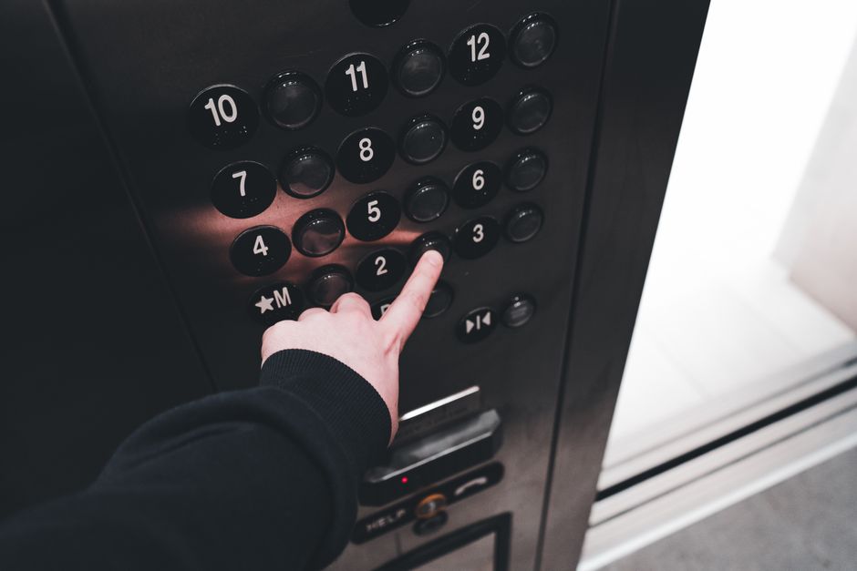 Close-up of an elevator control panel with numbered floor buttons