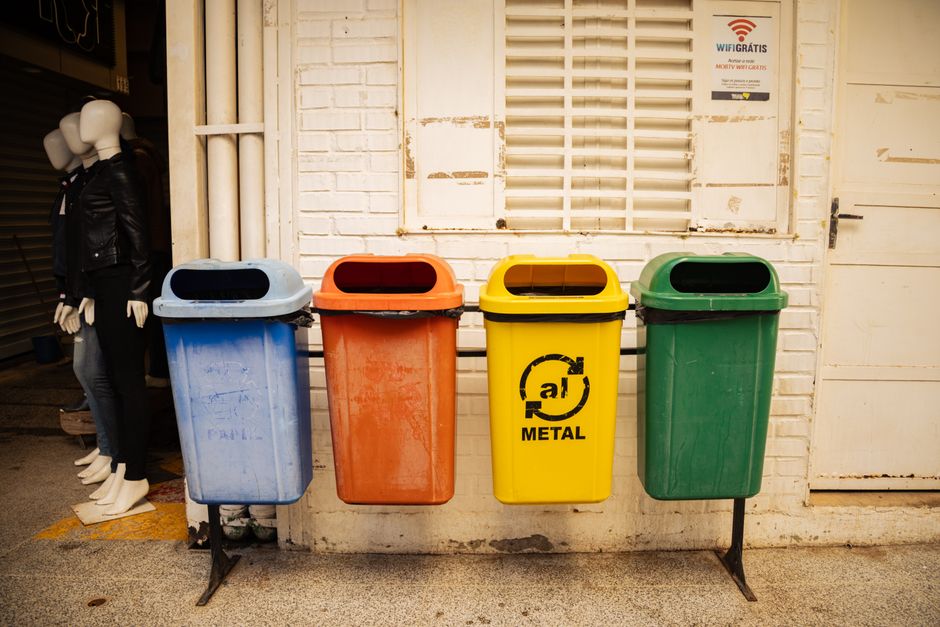 Recycling bins lined up in a shared apartment building trash room