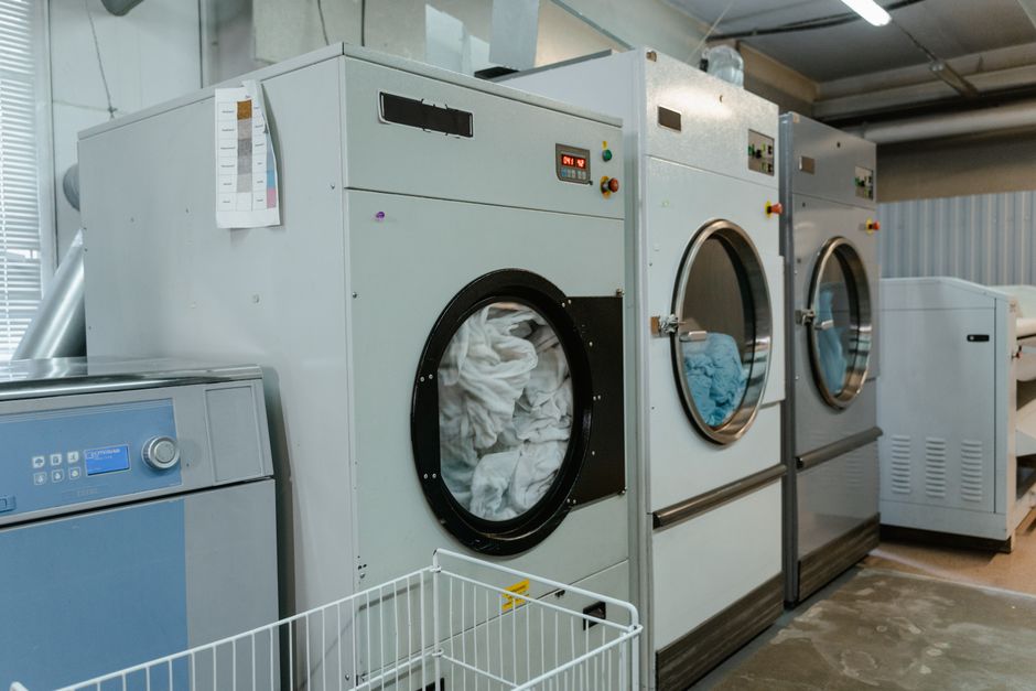 A clothes dryer running in an apartment laundry area, where scented detergent and dryer sheets can travel through shared vent