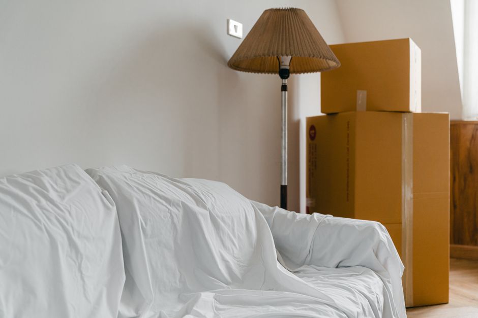 Stacked cardboard moving boxes in a cleared-out apartment ready for move-out day