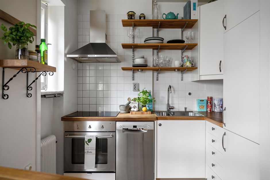 A compact apartment kitchen with counters and cabinets all within arm's reach