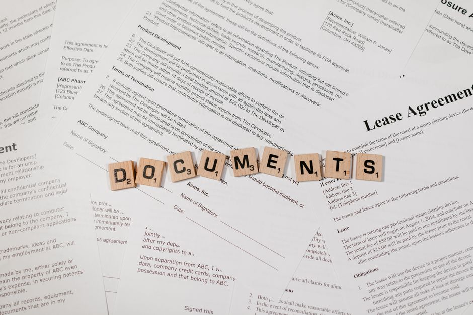 A lease renewal letter and rental documents laid out on a kitchen table