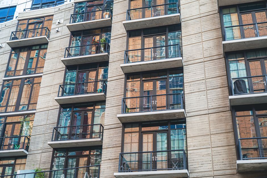 Two neighboring apartment balconies separated only by a low divider