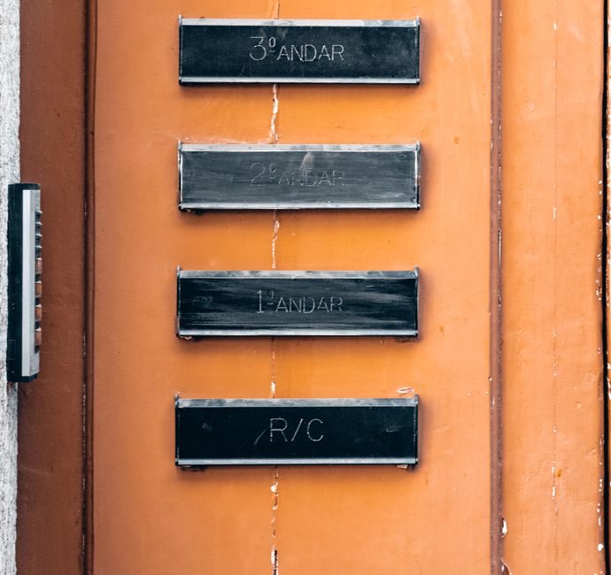 A shared apartment hallway with numbered doors, where a bedbug problem can travel between units.