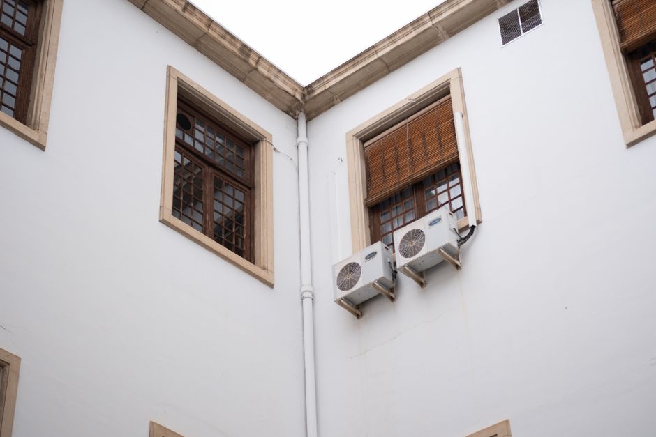 A window air conditioning unit mounted securely in an apartment window frame