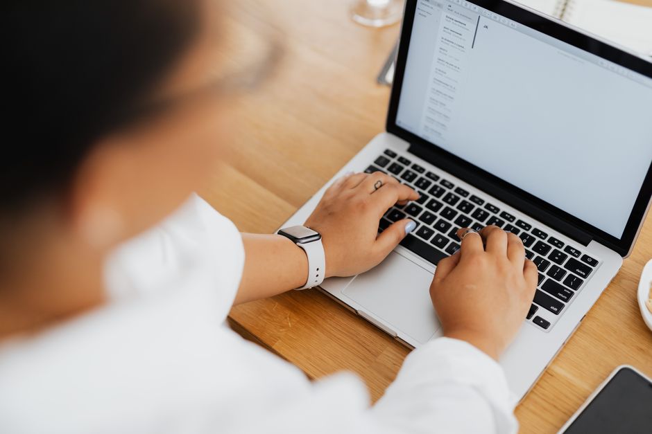 Resident writing a calm, documented message to building management on a laptop