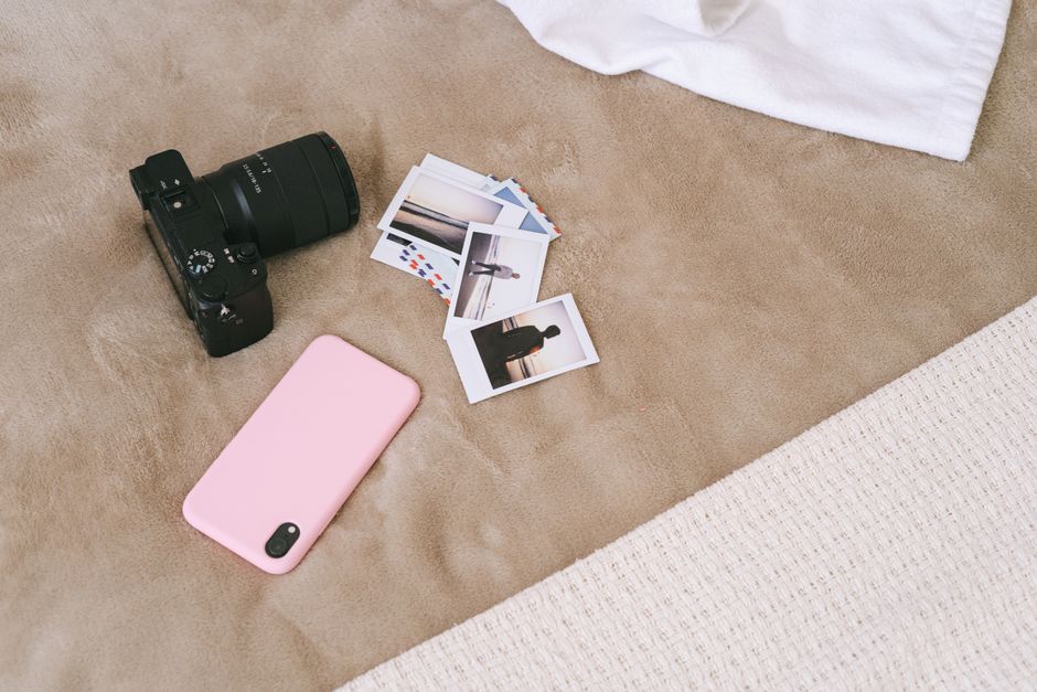 A person photographing household belongings with a smartphone to build a home inventory