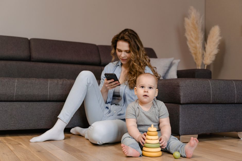A toddler playing safely on the floor of a childproofed apartment living room