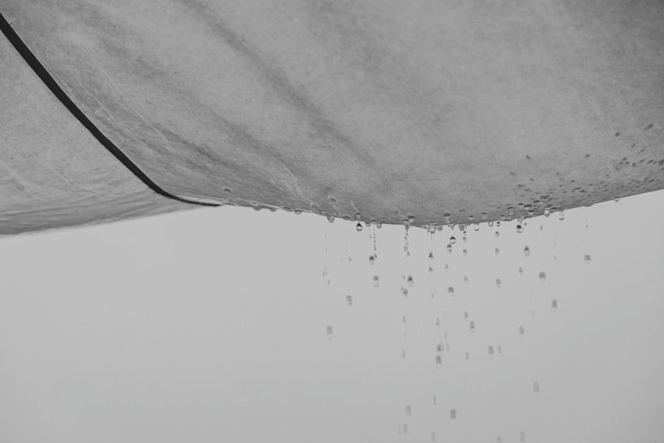 A water stain spreading across an apartment ceiling from a slow leak
